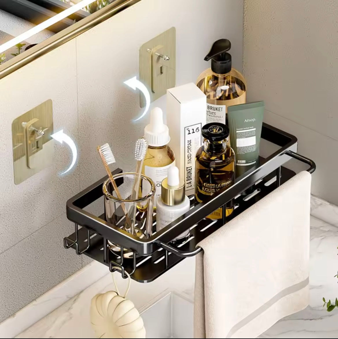 Black bathroom soap holder shelf with hooks and towel rail mounted above a basin