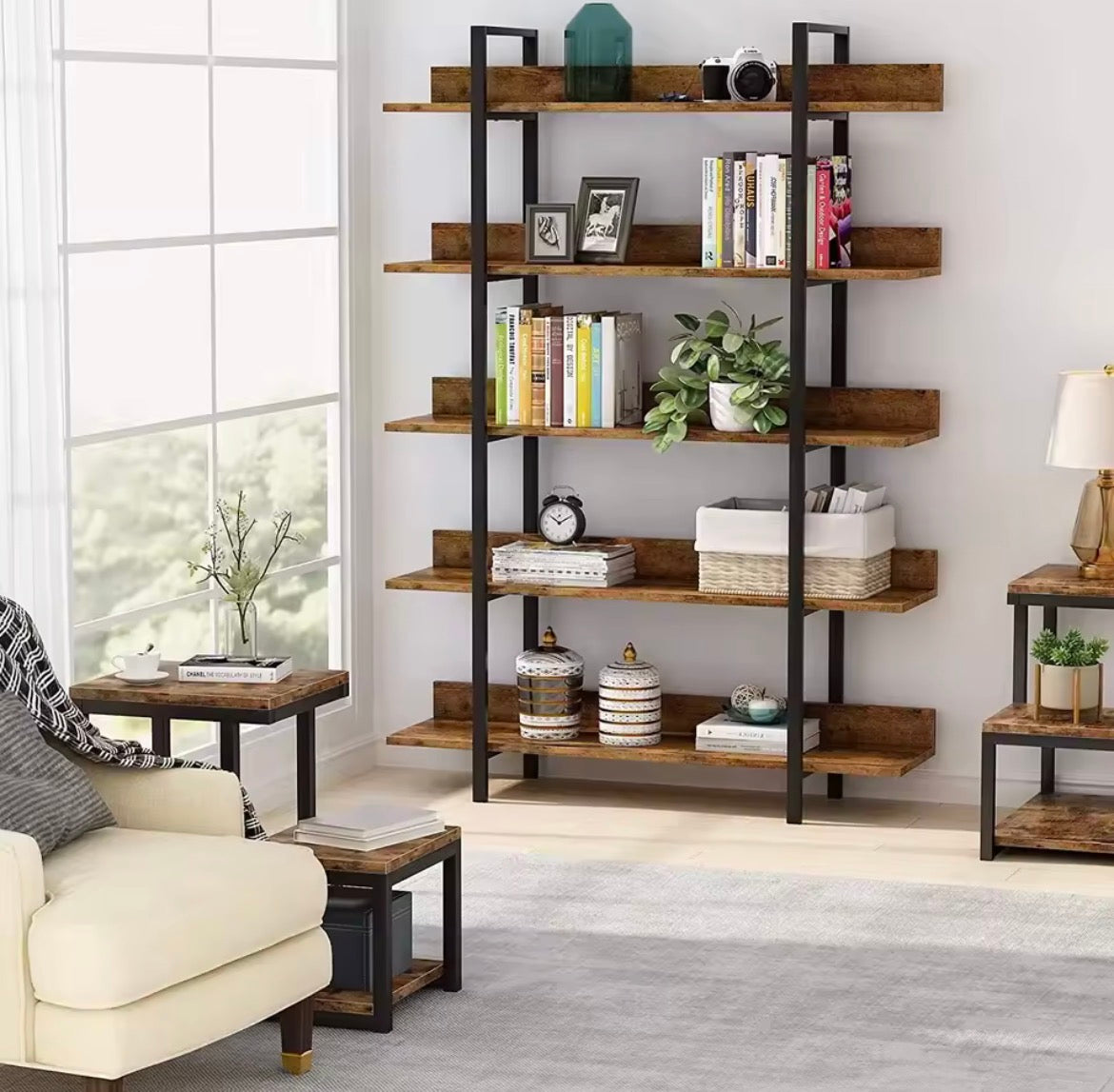 Tall brown and black five-tier industrial bookcase styled in a bright living room