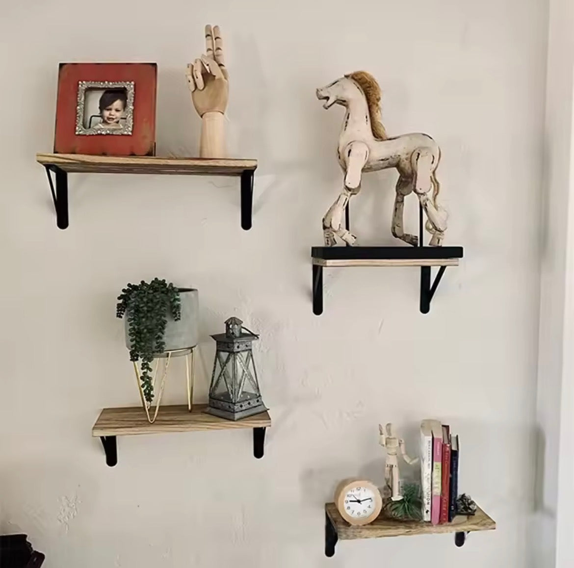 Wooden wall shelves displayed with decor and books